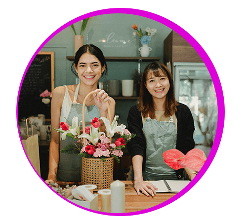 Owner and worker of flower shop smiling